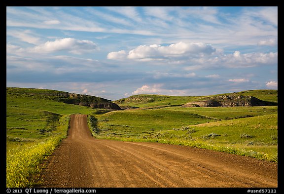 Gravel road, rolling hills and badlands. North Dakota, USA