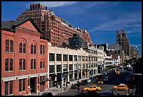 Taxi cars in streets and brick buildings. NYC, New York, USA