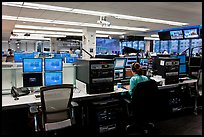 Bloomberg News analyst working in front of many screens. NYC, New York, USA ( color)