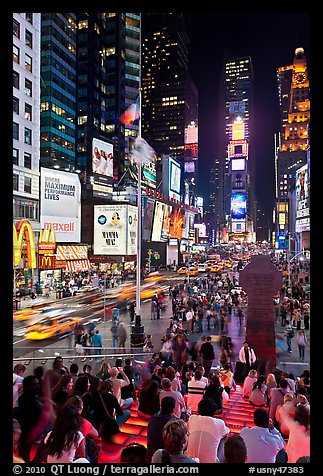 One Times Square at night and Francis Duffy monument. NYC, New York, USA