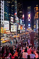 One Times Square at night and Francis Duffy monument. NYC, New York, USA