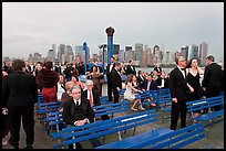 Black Tie gala guests on boat deck, New York harbor. NYC, New York, USA (color)