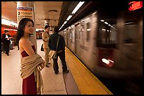 Young woman and arriving train on subway platform. NYC, New York, USA ( color)