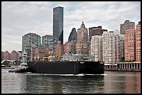 Barge on Hudson River and Manhattan waterfront. NYC, New York, USA