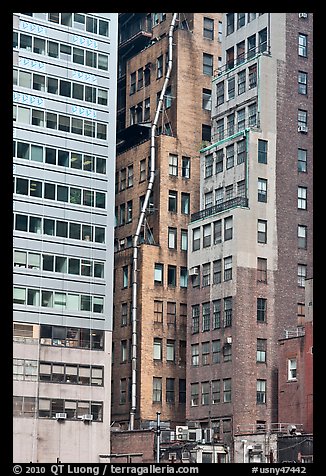 Old high-rise buildings with exterior pipe. NYC, New York, USA