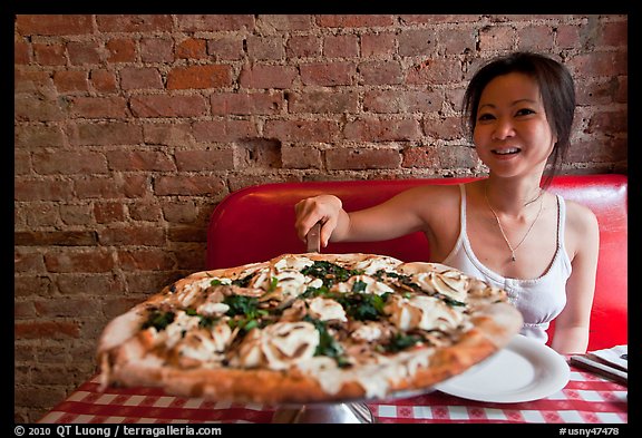 Woman getting slice of pizza at Lombardi. NYC, New York, USA (color)