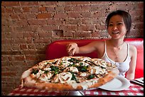 Woman getting slice of pizza at Lombardi. NYC, New York, USA (color)