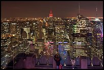 Woman on observation platform of Rockefeller center at night. NYC, New York, USA