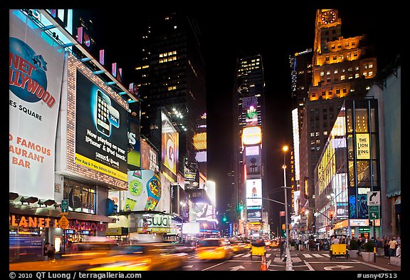 Taxis in motion, neon lights, Times Squares at night. NYC, New York, USA