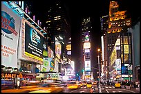 Taxis in motion, neon lights, Times Squares at night. NYC, New York, USA (color)