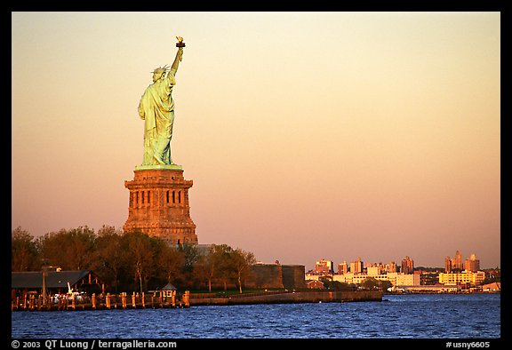 Statue of Liberty and Liberty Island from the back, sunset. NYC, New York, USA