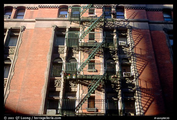 Emergency exit staircases on the side of a building. NYC, New York, USA (color)