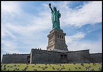 Statue of Liberty from lawn with pigeons, Statue of Liberty National Monument. NYC, New York, USA ( color)