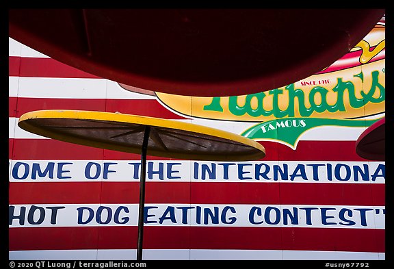 Sun umbrellas and hot dog eating contest wall. New York, USA (color)