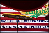 Sun umbrellas and hot dog eating contest wall. New York, USA ( color)