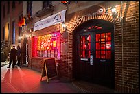 Two men on sidewalk and Stonewall Inn at night, Stonewall National Monument. NYC, New York, USA ( color)