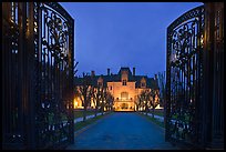 Entrance gate and historic mansion building at night. Newport, Rhode Island, USA