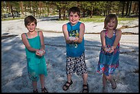 Children in summer dress holding large hailstones, Black Hills National Forest. Black Hills, South Dakota, USA ( color)