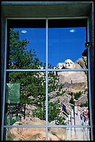 Cliff and sculptures reflected in a window, Mount Rushmore National Memorial. South Dakota, USA