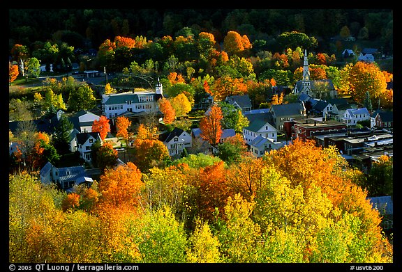 Village surounded by trees in brilliant fall colors. Vermont, New England, USA