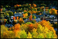 Village surounded by trees in brilliant fall colors. Vermont, New England, USA (color)