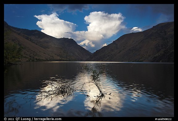 Thunderstorm clouds at sunrise reflected in reservoir. Hells Canyon National Recreation Area, Idaho and Oregon, USA