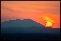 Sun rising and Big Southern Butte. Craters of the Moon National Monument and Preserve, Idaho, USA ( color)