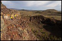 Echo crater with brightly colored rocks and Crescent Butte. Craters of the Moon National Monument and Preserve, Idaho, USA ( color)
