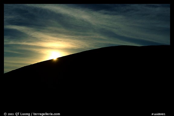 Sun at the rim of a cinder cone, sunrise, Craters of the Moon National Monument. Idaho, USA