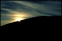 Sun at the rim of a cinder cone, sunrise, Craters of the Moon National Monument. Idaho, USA (color)