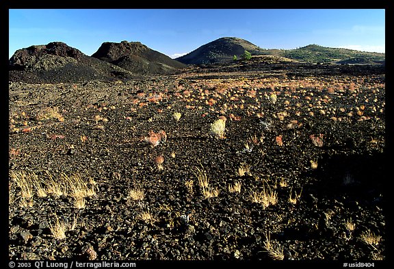 Scoria field with grasses and cinder cones. Craters of the Moon National Monument and Preserve, Idaho, USA (color)
