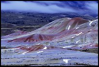 Painted hills and fog, winter dusk. John Day Fossils Bed National Monument, Oregon, USA (color)