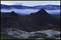 Buttes and fog at dusk. John Day Fossils Bed National Monument, Oregon, USA