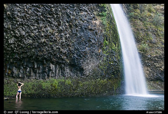 Woman in bikini at the base of Horsetail Falls. Columbia River Gorge, Oregon, USA (color)