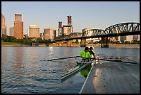 Rowers on double-oar shell lauching from deck in front of skyline. Portland, Oregon, USA ( color)