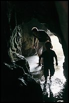 Boy and man exploring sea cave. Bandon, Oregon, USA