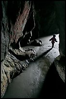 Infant walking out of sea cave. Bandon, Oregon, USA