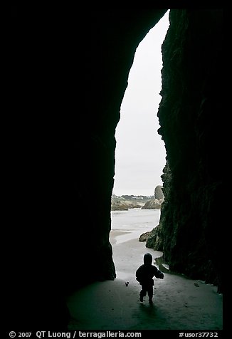Infant and sea cave opening from inside. Bandon, Oregon, USA
