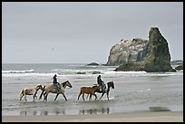 Women ridding horses on beach. Bandon, Oregon, USA (color)