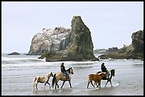 Women horse-riding on beach. Bandon, Oregon, USA (color)