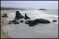 Beach at Face Rock with two people walking. Bandon, Oregon, USA (color)