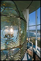 Rotating light inside Cape Blanco Lighthouse tower and landscape. Oregon, USA (color)
