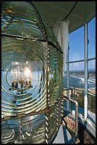 Rotating light inside Cape Blanco Lighthouse tower and landscape. Oregon, USA