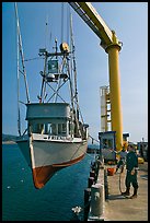 Fishing boat hoisted from water, Port Orford. Oregon, USA (color)