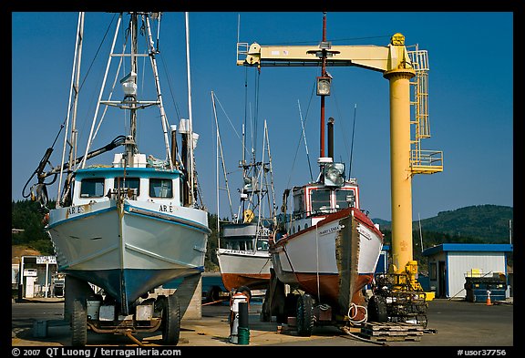 Fishing boats parked on deck with hoist behind, Port Orford. Oregon, USA