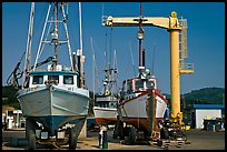 Fishing boats parked on deck with hoist behind, Port Orford. Oregon, USA