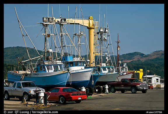 Fishing boats and cars parked on deck, Port Orford. Oregon, USA