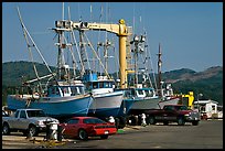 Fishing boats and cars parked on deck, Port Orford. Oregon, USA (color)