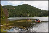 Family kayaking on Devils Lake. Oregon, USA