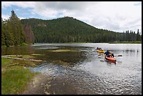 Parents towing children in kayak, Devils Lake. Oregon, USA ( color)